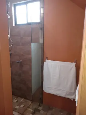 a bathroom with a shower with a white towel at Small Country House in Monterrey