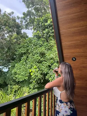 a woman standing on a balcony looking out the window at Small Country House in Monterrey