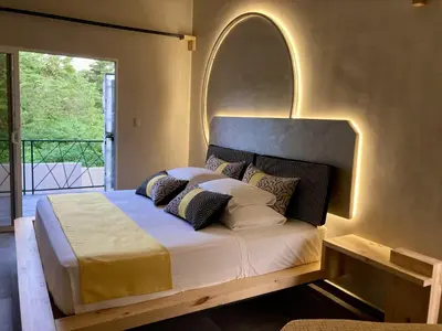 a bedroom with a bed with an arch above it at Pierre and Colors TAMARINDO in Tamarindo
