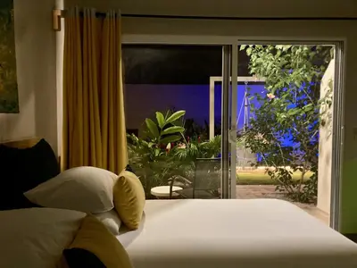 a bedroom with a bed and a large window at Pierre and Colors TAMARINDO in Tamarindo