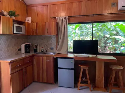 a kitchen with a desk with a computer on it at Monkey House, Monterrey in San Cristóbal