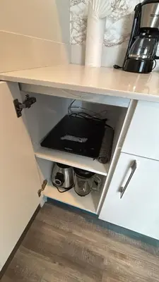 a cupboard in a kitchen with a coffee maker at Studio en piso 29 Secrt Sabana in San José