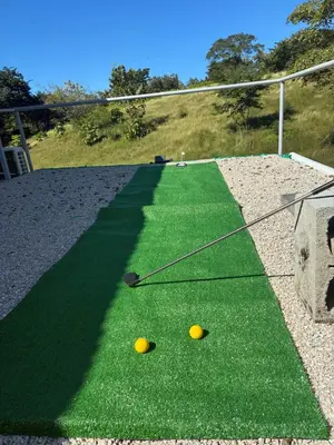 two golf balls on a fake grass field at Contenedor Santa Cruz en Guanacaste piscina in Paraíso