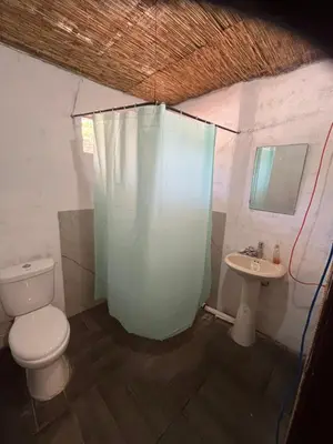 a bathroom with a toilet and a sink at Contenedor Santa Cruz en Guanacaste piscina in Paraíso