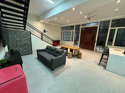 a living room with a couch and a table at bambu house in Alajuela City