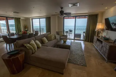a living room with a couch and a table at Spectacular 3 bedroom Penthouse at Crocs Resort Casino in Jacó