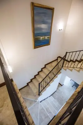 a staircase in a building with a picture on the wall at Spectacular 3 bedroom Penthouse at Crocs Resort Casino in Jacó