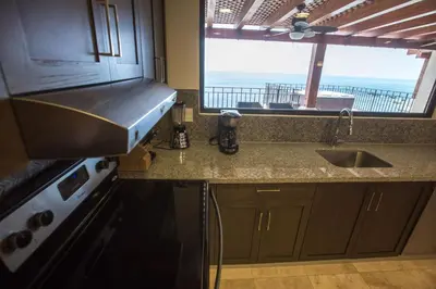 a kitchen with a sink and a window at Spectacular 3 bedroom Penthouse at Crocs Resort Casino in Jacó