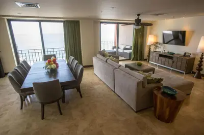 a living room with a table and a couch at Spectacular 3 bedroom Penthouse at Crocs Resort Casino in Jacó