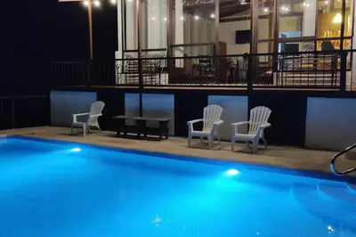 a group of chairs and a table and a pool at Orange Hills -Atenas- in Barrio Jesús
