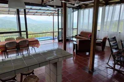 a living room with a table and chairs at Orange Hills -Atenas- in Barrio Jesús