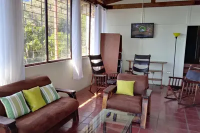 a living room with couches and chairs and a table at Orange Hills -Atenas- in Barrio Jesús