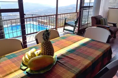 a pineapple on a table with a view of a pool at Orange Hills -Atenas- in Barrio Jesús