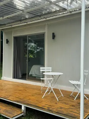 a patio with chairs and a table on a deck at Cautiva Sleep Inn in Guácimo