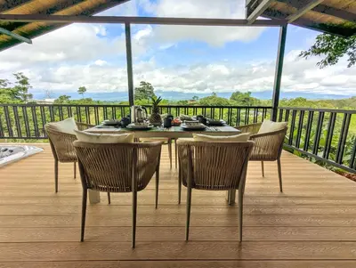 a table and chairs on a deck with a view at Serene Hills in Fortuna