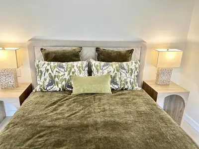 a bedroom with a large bed with two lamps at J-PacP506 condo in Jacó