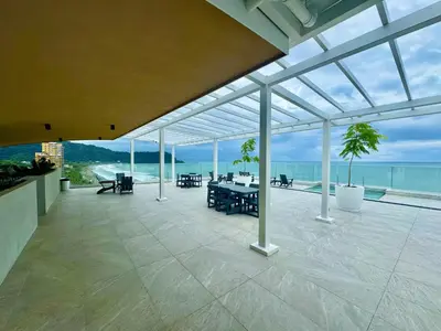 a large conservatory with a patio with a view of the ocean at J-PacP506 condo in Jacó
