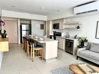 a kitchen and living room with a bar and a couch at J-PacP506 condo in Jacó