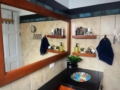a bathroom with a sink and a mirror at Designer-Inspired 1Bed1Bath Condo Close to Beach in Coco