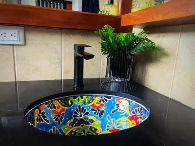 a bathroom sink with a flower pattern on it at Designer-Inspired 1Bed1Bath Condo Close to Beach in Coco