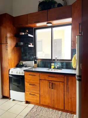 a kitchen with a stove and a sink and a window at Designer-Inspired 1Bed1Bath Condo Close to Beach in Coco