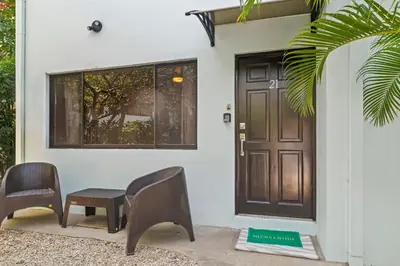 a house with two chairs and a door at Casa Verde 2b2b Completely Renovated Ground Unit in Coco