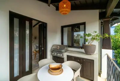 a patio with a table and chairs and a kitchen at Calle La Ronda 18 At Las Catalinas in Playa Danta