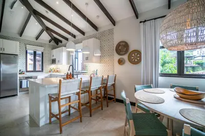 a kitchen and dining room with a table and chairs at Calle La Ronda 18 At Las Catalinas in Playa Danta