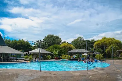 a large swimming pool with people in the water at Hotel del Sur in San Isidro