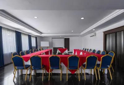 a conference room with a red table and chairs at Hotel del Sur in San Isidro