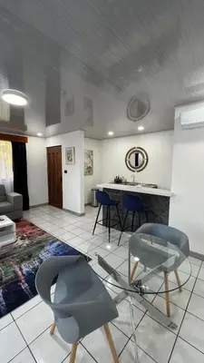 a living room with two chairs and a table at Hotel del Sur in San Isidro