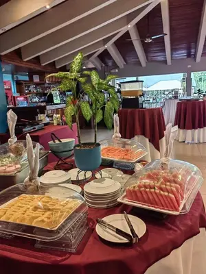 a table filled with food on a red table cloth at Hotel del Sur in San Isidro