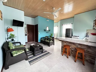 a living room with a couch and a bar at Apartamento en Manuel Antonio in Quepos