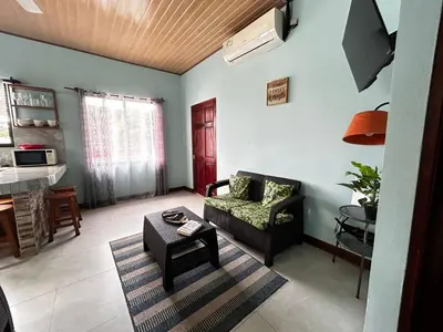 a living room with a couch and a table at Apartamento en Manuel Antonio in Quepos