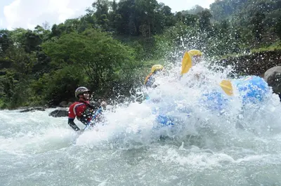 a group of people in a raft in the water at Rafiki Safari Lodge in Savegre