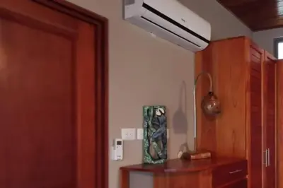 a room with a door and a cabinet and a fan at Casita Morpho, high speed wifi in Uvita