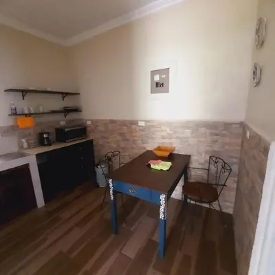 a kitchen with a table and chairs in a room at The garden suite in Alajuela City