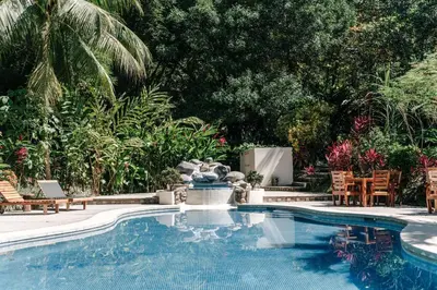 a swimming pool with a fountain in a yard at Star Mountain Jungle Lodge - Only 4x4 Vehicles, No Meals in Mal País