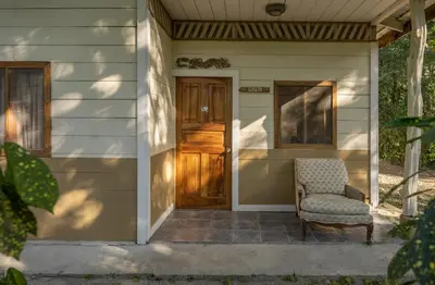 a chair sitting on the porch of a house at Star Mountain Jungle Lodge - Only 4x4 Vehicles, No Meals in Mal País