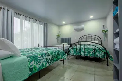 a bedroom with two beds and a window at Villa Margarita - Families Getaway in La Fortuna in Fortuna