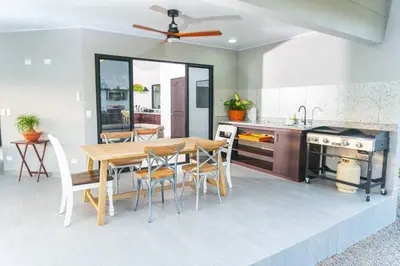 a kitchen with a wooden table and a dining room at Villa Margarita - Families Getaway in La Fortuna in Fortuna
