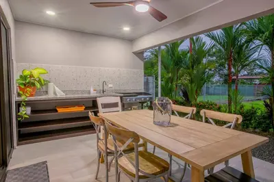 a kitchen with a wooden table and chairs at Villa Margarita - Families Getaway in La Fortuna in Fortuna