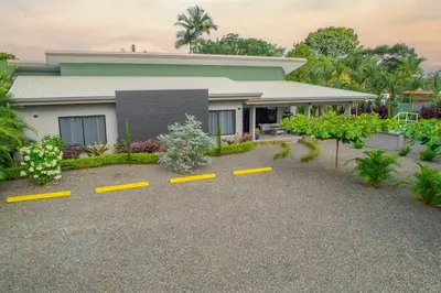 a house with yellow parking spots in front of it at Villa Margarita - Families Getaway in La Fortuna in Fortuna
