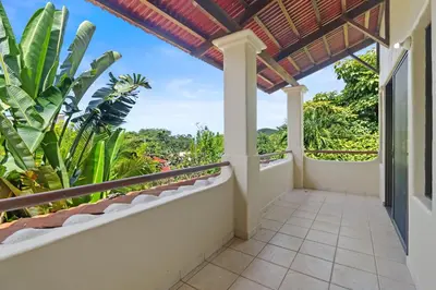 a balcony with a view of the jungle at Sunshine Escape with a Rooftop Patio in Coco