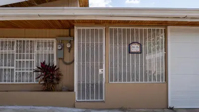 a house with white gates on the front door at Villa Paz in San José