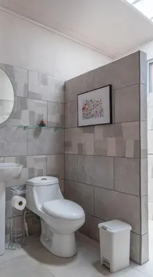 a bathroom with a toilet and a sink at Villa Paz in San José