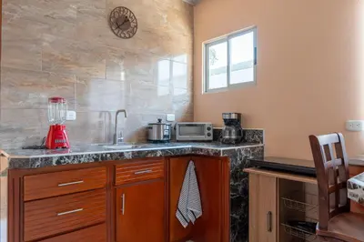 a kitchen with a sink and a counter with a blender at Villa Paz in San José