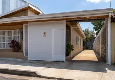 a garage with a white garage door in a house at Villa Paz in San José