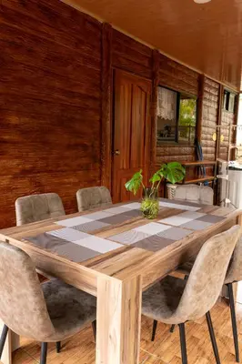 a dining room with a wooden table and chairs at Cabaña Timarama in Fortuna