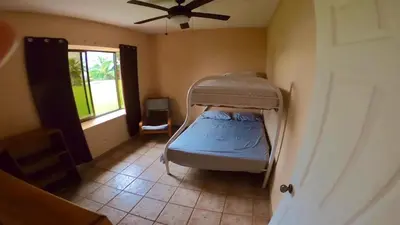 a bedroom with a bunk bed in a room with a window at Casa Vista Pacifico in Esterillos